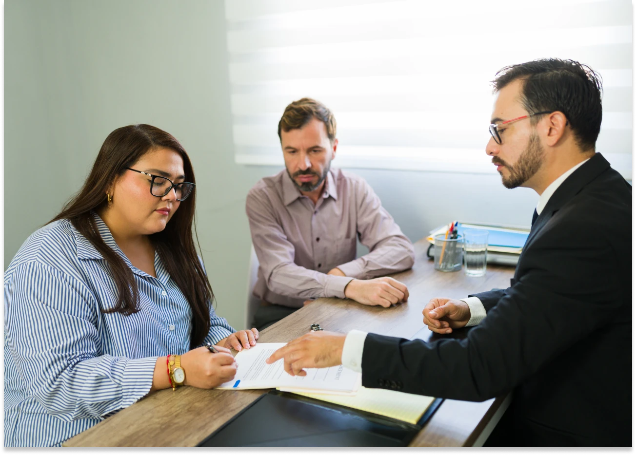People discussing documents in an office meeting.