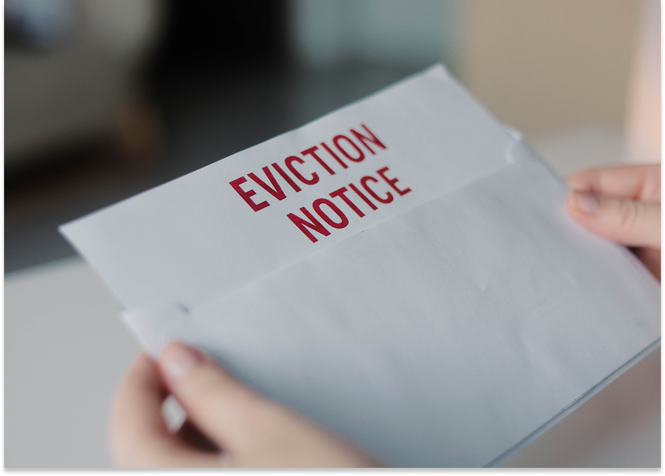 Eviction notice letter in someone's hands.
